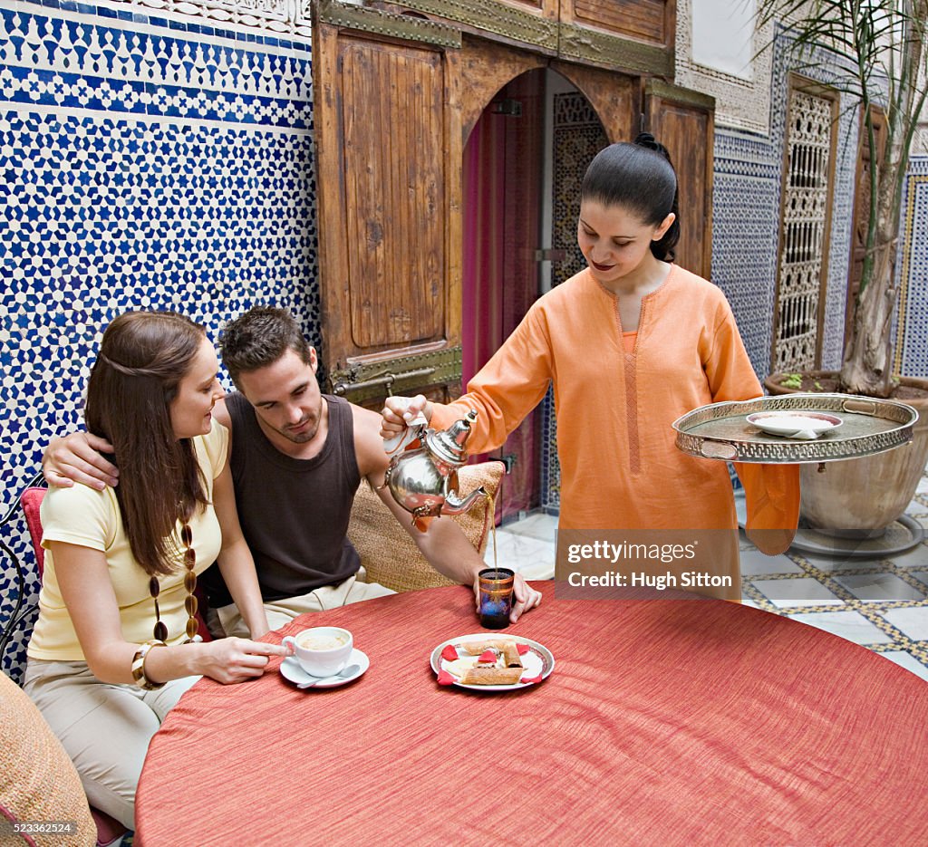 Waitress Pouring Tea for Couple