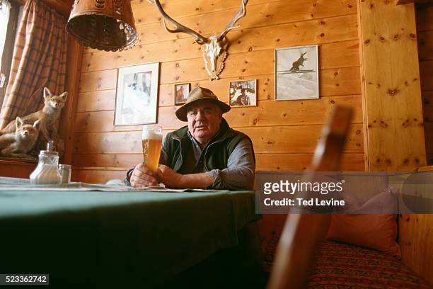 man sitting with beer in restaurant, bavaria, germany, europe - baviera foto e immagini stock