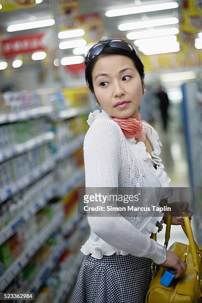 woman shoplifting - hidden object stock pictures, royalty-free photos & images