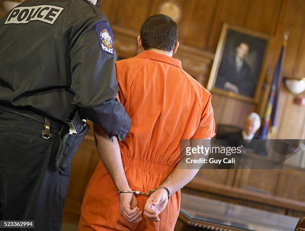 defendant standing before the judge - handbojor bildbanksfoton och bilder
