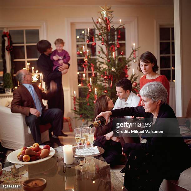 extended family around christmas tree - christmas family tree ストックフォトと画像