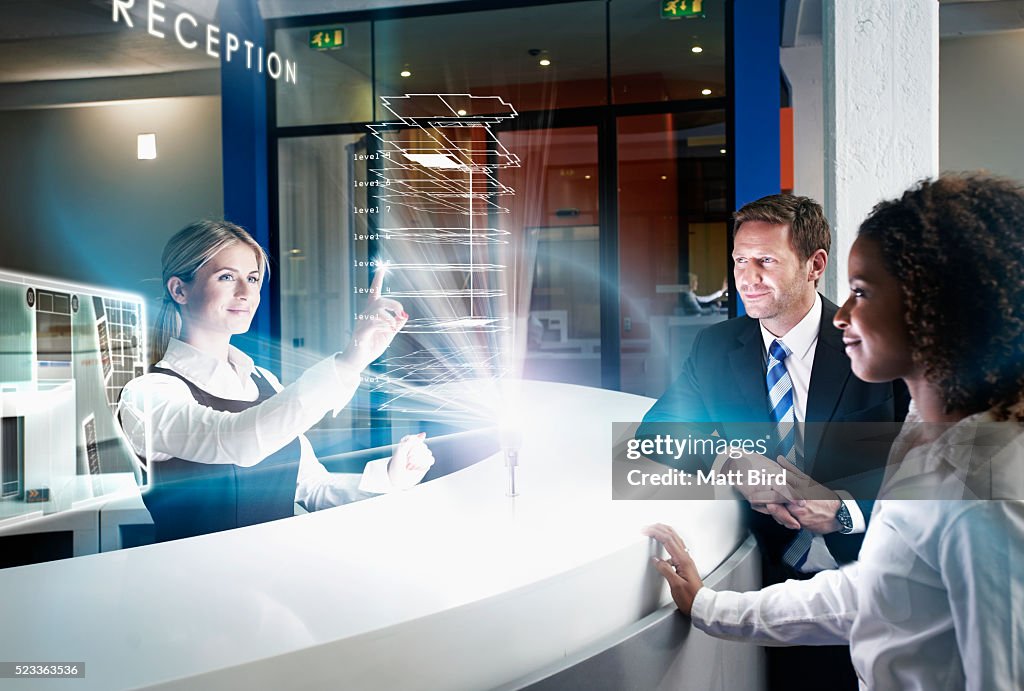 Woman showing hotel building and room plans on futuristic device