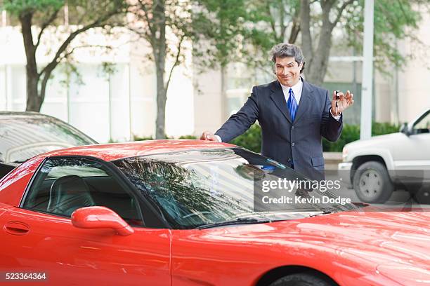 businessman with keys to sports car - know it all stock pictures, royalty-free photos & images