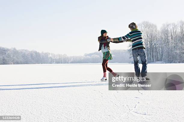 couple ice skating on frozen pond - ice skating 個照片及圖片檔