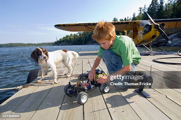 boy playing with toy car on pier - radio controlled handset stock pictures, royalty-free photos & images