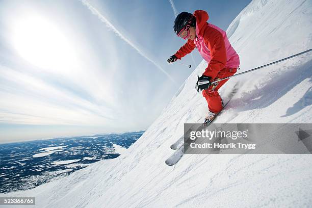 skier heading down slope - woman skiing stock pictures, royalty-free photos & images