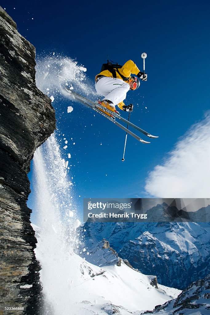 Skier Dropping Cliff in Swiss Alps