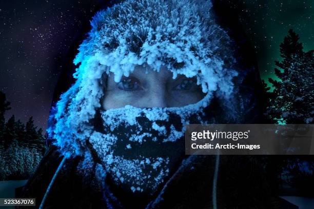 woman in extreme cold temperatures with icicles on her eyelashes, hat and scarf. - woman snow outside night stock pictures, royalty-free photos & images