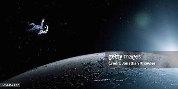 astronaut floating in space - astronaut stock pictures, royalty-free photos & images