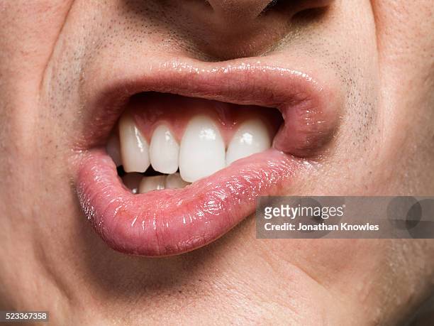 close-up of mouth - clenching teeth stock-fotos und bilder