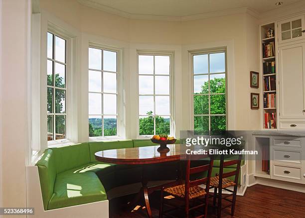 sunny breakfast nook with green banquette seating - window seat stockfoto's en -beelden