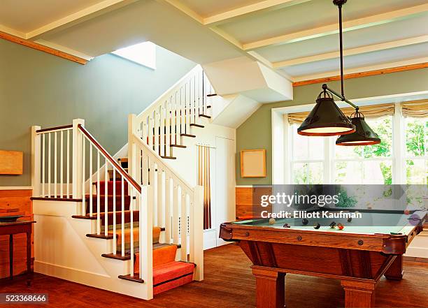 pool table is placed next to the staircase in a house - pool table fotografías e imágenes de stock