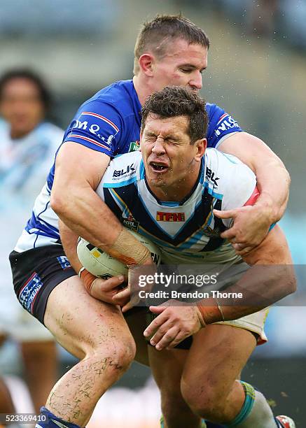 Greg Bird of the Titans receives a high tackle from Tim Browne of the Bulldogs during the round eight NRL match between the Canterbury Bulldogs and...