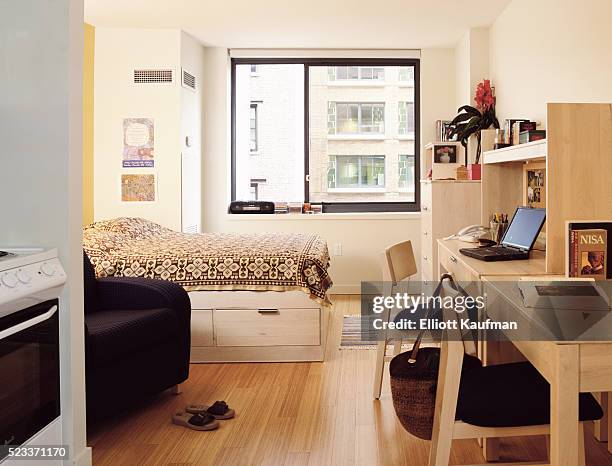 dorm room with storage bed and desks - dorm room stock pictures, royalty-free photos & images