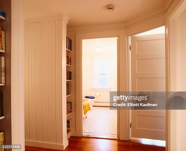 white beaded paneling in hallway leading to bathroom - bathroom door ストックフォトと画像