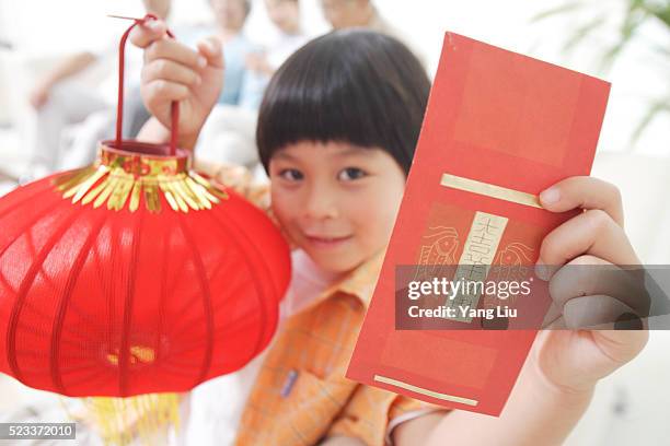 boy holding red envelope and lantern - woman red lantern stock pictures, royalty-free photos & images