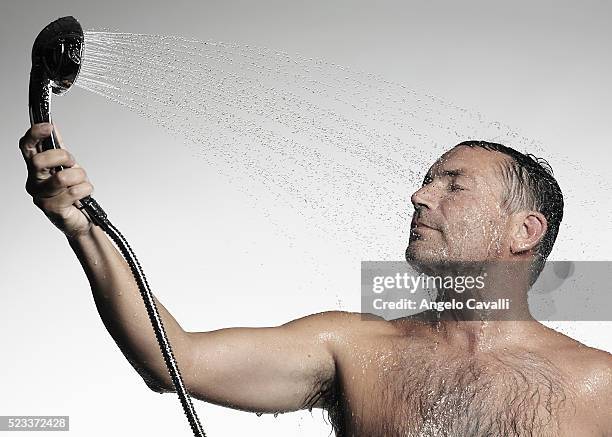 man taking shower - shower head stock pictures, royalty-free photos & images