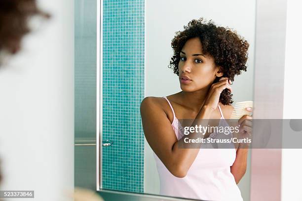 woman brushing hair - combing stock pictures, royalty-free photos & images