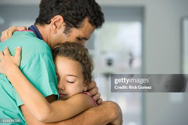 doctor hugging young patient - doctor children stock-fotos und bilder