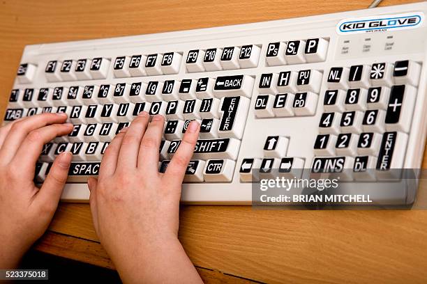 visually impared childl using specially large key computer key pad - assistive technology stock pictures, royalty-free photos & images