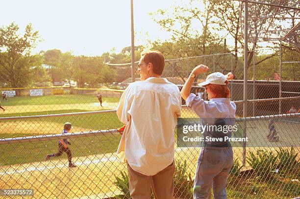 parents cheering at little league game - parents cheering stock pictures, royalty-free photos & images