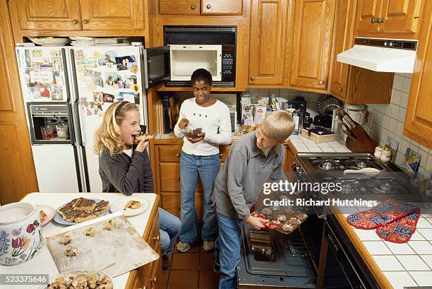 children making and enjoying sweets - vintage microwave stock pictures, royalty-free photos & images
