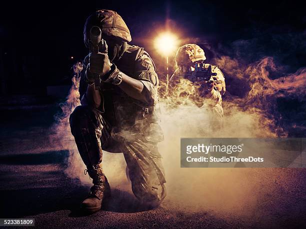 two soldiers in action - conflict stock pictures, royalty-free photos & images