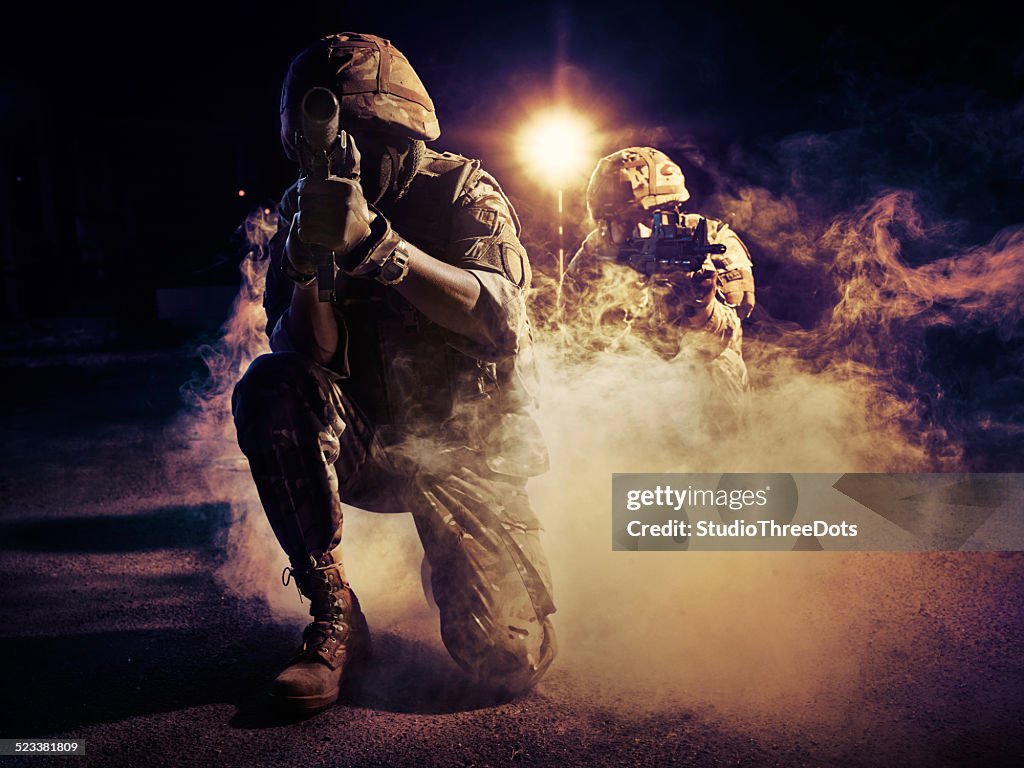Two soldiers in action
