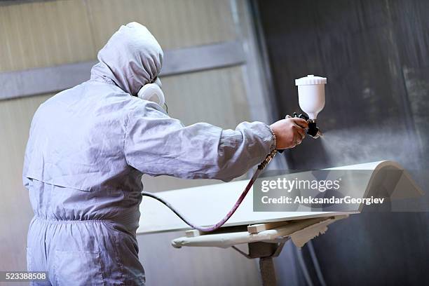 mechanic in painting booth spray wooden part of furniture - karosseriarbete bildbanksfoton och bilder