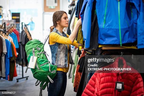 shopping woman in sports megastore - sports merchandise stock pictures, royalty-free photos & images