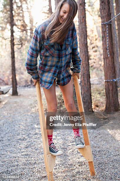 girl (8-9) walking on stilts - stilt stock pictures, royalty-free photos & images