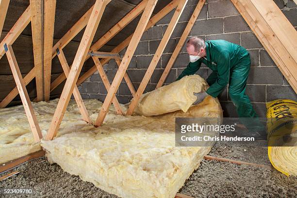 diy loft insulation by homeowner. - loft fotografías e imágenes de stock