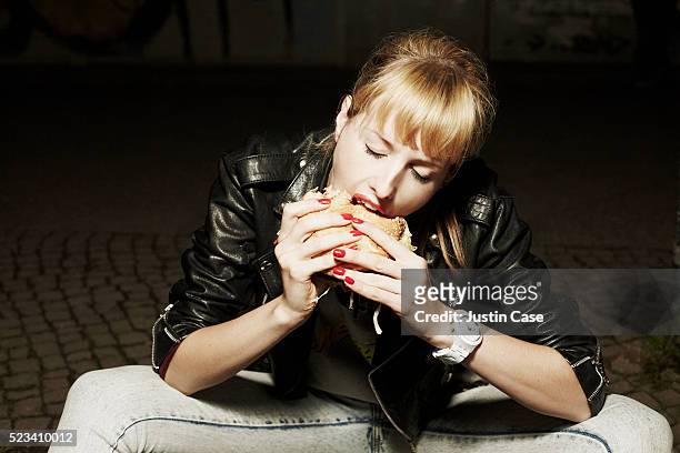 girl eating a burger - fashion food stock pictures, royalty-free photos & images