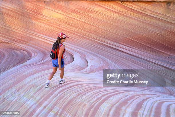woman hiking through sandstone canyon - antelope canyon stock pictures, royalty-free photos & images