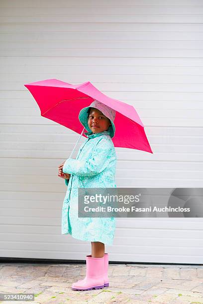 little girl wearing rain gear - vintage raincoat stock-fotos und bilder