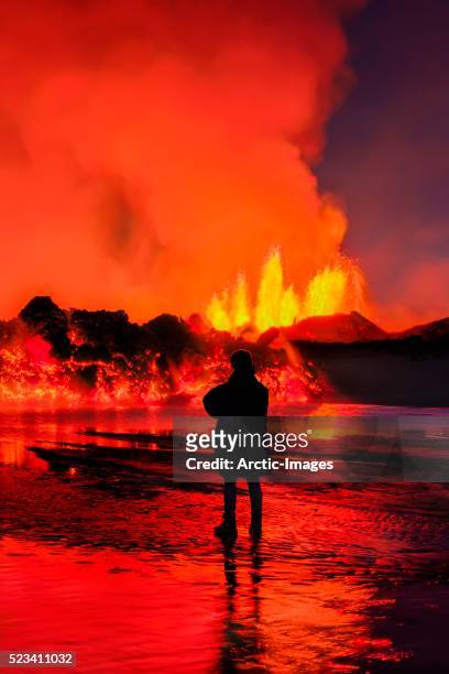 woman watching the lava flow at the holuhraun fissure eruption near bardarbunga volcano, iceland - volcanic landscape stock pictures, royalty-free photos & images