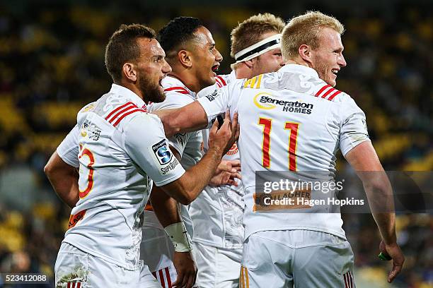 To R, Aaron Cruden, Toni Pulu, Sam Cane and Sam McNichol of the Chiefs celebrate a try during the round nine Super Rugby match between the Hurricanes...