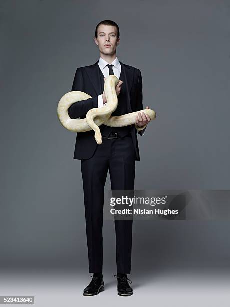 man in suit holding snake - pitão imagens e fotografias de stock