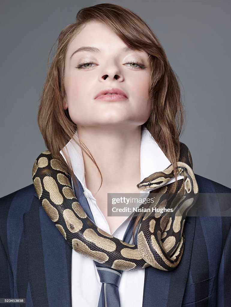 Woman in suit with snake around her neck