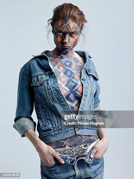 portrait of woman with snake makeup on her face and body - denim jacket bildbanksfoton och bilder