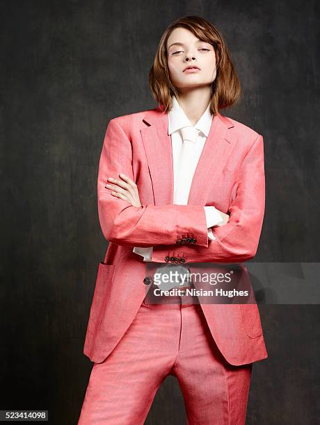 portrait of woman wearing pink suit - pink suit stockfoto's en -beelden