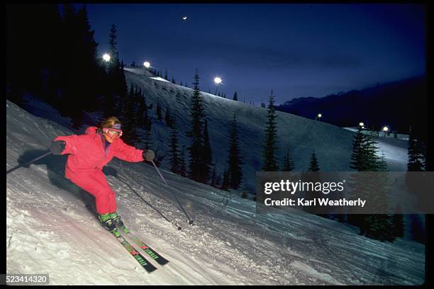 night skier on slopes of stevens pass - night skiing stock pictures, royalty-free photos & images