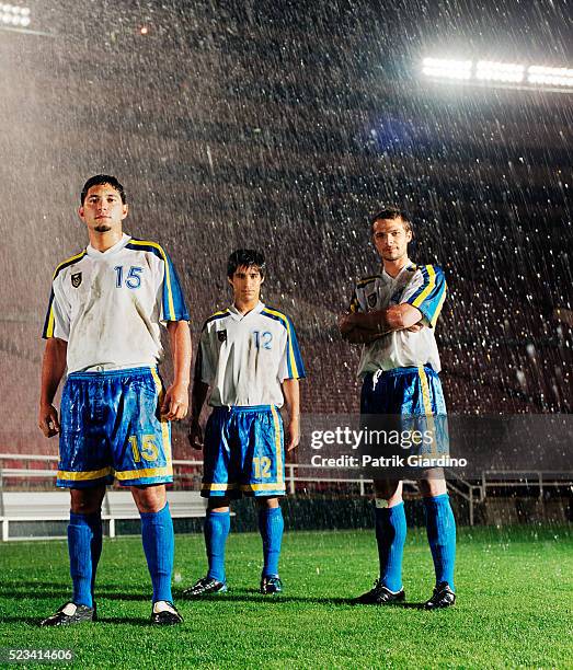 soccer players standing in downpour - sad soccer player stock pictures, royalty-free photos & images