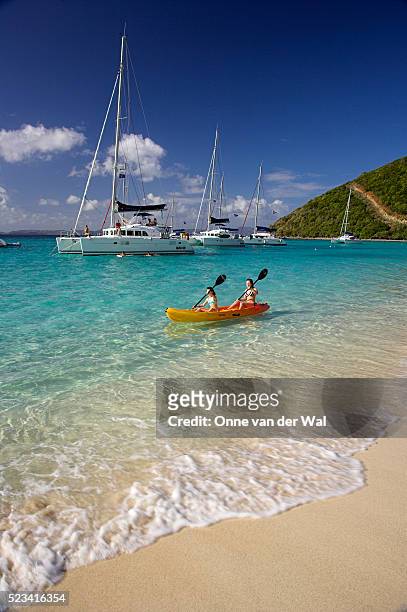 girls kayaking by the shore - virgin islands stock pictures, royalty-free photos & images