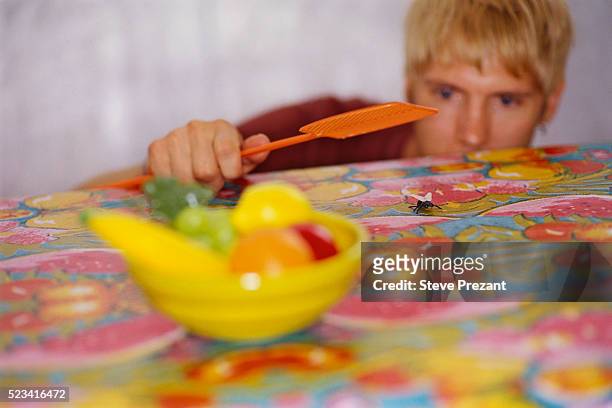 man preparing to kill fly - fly insect stock pictures, royalty-free photos & images