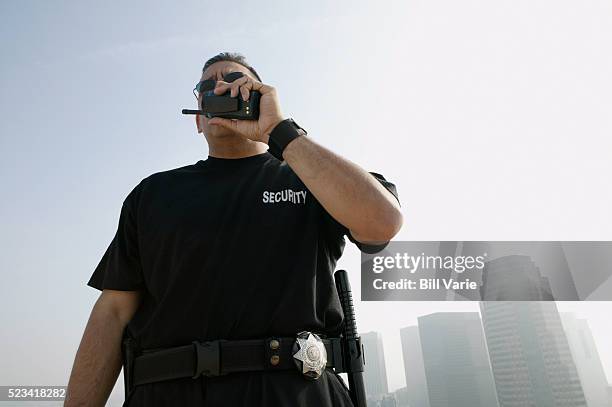 security guard talking on walkie-talkie - security guard bildbanksfoton och bilder