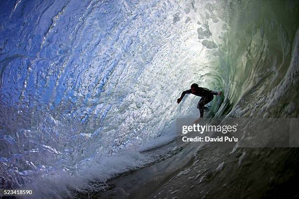 surfer riding a tube - surf tube stock-fotos und bilder