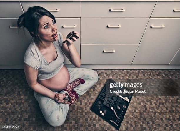 pregnant teenager caught eating chocolates - colpevolezza foto e immagini stock
