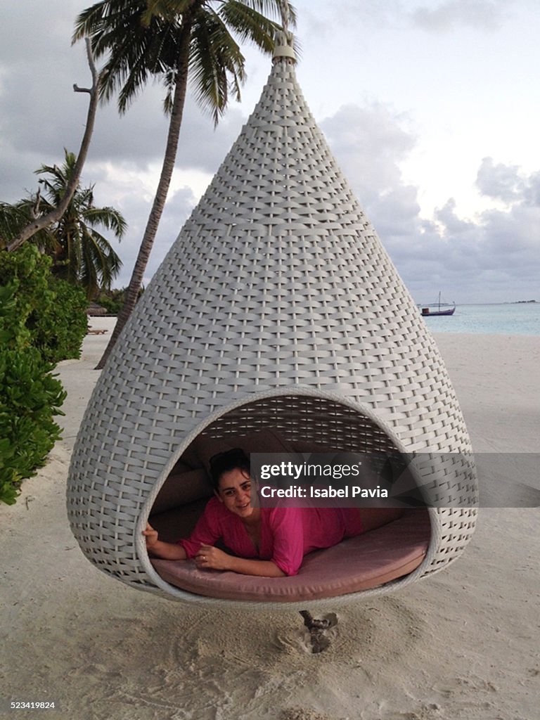 Woman relaxed in hut on beach
