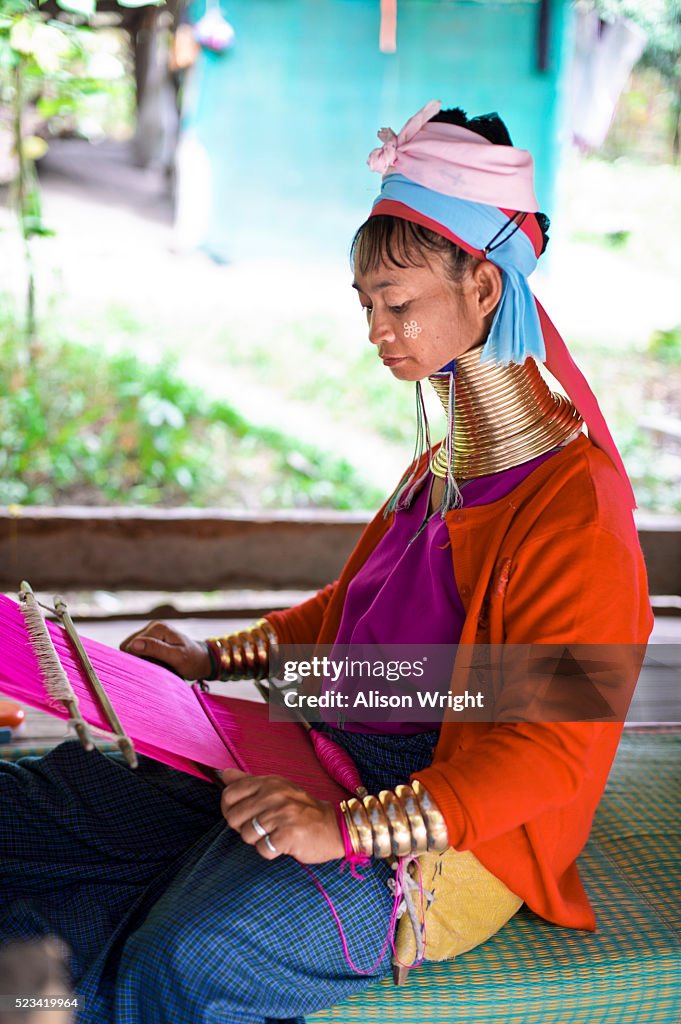Long neck Padaung Karen tribe woman weaving